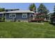 Backyard view of home featuring a wood deck and large grass lawn at 8055 Foxchase Dr, Indianapolis, IN 46256