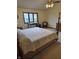 Bedroom featuring a four-poster bed with light colored carpet and a window at 8055 Foxchase Dr, Indianapolis, IN 46256