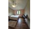 Bedroom featuring wood floors, neutral paint, a window, and a ceiling fan at 8055 Foxchase Dr, Indianapolis, IN 46256