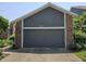 Exterior of garage with neutral siding and brick accent, with house number 8055 at 8055 Foxchase Dr, Indianapolis, IN 46256