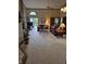 Spacious living room with brick fireplace, carpeted floors, and sliding door access to the backyard deck at 8055 Foxchase Dr, Indianapolis, IN 46256