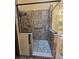 Modern glass enclosed shower featuring textured tile, a bench, and convenient grab bars at 8055 Foxchase Dr, Indianapolis, IN 46256