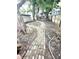 A brick path leads through the large backyard with mature trees and a privacy fence at 866 Fletcher Ave, Indianapolis, IN 46203