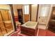 Bathroom featuring a jetted tub, glass-enclosed shower and ornate red tile flooring at 866 Fletcher Ave, Indianapolis, IN 46203