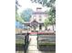 Charming multi-story home featuring a welcoming front porch and a decorative fence at 866 Fletcher Ave, Indianapolis, IN 46203