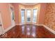 Living room showcasing hardwood floors, and bay window, bathed in natural light at 866 Fletcher Ave, Indianapolis, IN 46203
