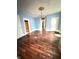 A traditional living room features hardwood floors, chandelier, and classic trim at 866 Fletcher Ave, Indianapolis, IN 46203