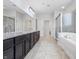A primary bathroom with a double vanity, bathtub, and glass enclosed shower at 902 Racetime Rd, Westfield, IN 46074