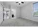 An empty bedroom with carpet flooring, ceiling fan, and a window that provides natural light at 902 Racetime Rd, Westfield, IN 46074