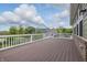 Large wooden deck with white railings overlooking the backyard and neighboring house at 902 Racetime Rd, Westfield, IN 46074