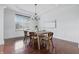 Bright dining room boasts hardwood floors, a modern chandelier, and large window providing natural light at 902 Racetime Rd, Westfield, IN 46074
