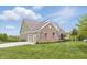 Spacious home with a brick facade, well-kept lawn, and a three-car garage, providing ample parking at 902 Racetime Rd, Westfield, IN 46074