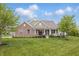 Beautiful exterior view of a brick and siding home with a well-maintained lawn and mature trees at 902 Racetime Rd, Westfield, IN 46074