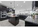Open kitchen with stainless appliances, double islands, granite countertops, and modern lighting at 902 Racetime Rd, Westfield, IN 46074