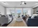 Open-concept living room with hardwood floors, modern furnishings, and an abundance of natural light at 902 Racetime Rd, Westfield, IN 46074