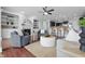 Stylish living area featuring hardwood floors, built-in shelving, and an open layout connecting to the kitchen at 902 Racetime Rd, Westfield, IN 46074
