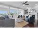 Bright and spacious living room with hardwood floors, stylish seating, and large windows overlooking the backyard at 902 Racetime Rd, Westfield, IN 46074