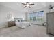 Serene primary bedroom with tray ceiling, plush carpeting, and a large window with views at 902 Racetime Rd, Westfield, IN 46074