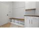 A mudroom with coat rack, bench seating with storage, and white cabinets with a butcher block counter at 902 Racetime Rd, Westfield, IN 46074
