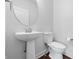 Simple half bathroom featuring pedestal sink, toilet, and neutral wall paint at 902 Racetime Rd, Westfield, IN 46074