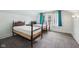 Bright bedroom featuring two beds, natural light, and patterned carpeting at 910 E Pike St, Martinsville, IN 46151