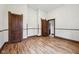 Spacious room with hardwood floors, historic trim, and multiple doorways at 910 E Pike St, Martinsville, IN 46151