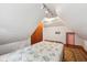 Cozy bedroom featuring one bed, hardwood floors, unique lighting, and attic style at 910 E Pike St, Martinsville, IN 46151