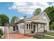 Home exterior with a brick patio, a covered porch, and lush greenery at 910 E Pike St, Martinsville, IN 46151