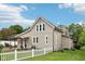 Exterior view of a lovely home with a white picket fence and lush green lawn at 910 E Pike St, Martinsville, IN 46151