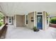 Spacious front porch with a blue front door and tasteful decor at 910 E Pike St, Martinsville, IN 46151
