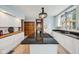 Open concept kitchen with granite countertops, white cabinets, stainless steel appliances, and wood floors at 910 E Pike St, Martinsville, IN 46151