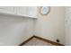 Efficient laundry area with storage cabinets and a small octagonal window at 910 E Pike St, Martinsville, IN 46151