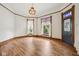 Bright living room with hardwood floors, large windows with vintage trim, and decorative light fixture at 910 E Pike St, Martinsville, IN 46151