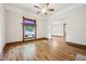 Spacious living room with hardwood floors, detailed vintage trim, and an adjacent doorway at 910 E Pike St, Martinsville, IN 46151