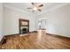 Cozy living room featuring a decorative fireplace, hardwood floors, and an adjacent room for entertaining at 910 E Pike St, Martinsville, IN 46151
