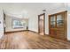 Inviting living room featuring hardwood floors, vintage trim, and a built-in cabinet at 910 E Pike St, Martinsville, IN 46151