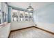 Bright sun room with ample natural light through multiple windows and beautiful blue accents at 910 E Pike St, Martinsville, IN 46151