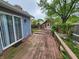 View of outdoor back deck with wooden fence, shed, and lush landscaping for privacy and outdoor living at 9134 Jene Ct, Indianapolis, IN 46234
