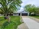 Charming home featuring a two-car garage, lovely landscaping, and a well-maintained front yard at 9134 Jene Ct, Indianapolis, IN 46234