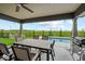 Covered outdoor patio featuring a dining set and grill, perfect for entertaining near the pool at 920 Alba Dr, Lebanon, IN 46052