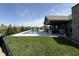 Backyard featuring an in-ground pool, patio area, outdoor kitchen, and well-maintained landscaping at 920 Alba Dr, Lebanon, IN 46052