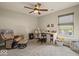 Relaxing home office features a ceiling fan, chair, and desk with natural light from a window at 920 Alba Dr, Lebanon, IN 46052