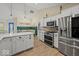 This kitchen features stainless appliances, white cabinets, an island, and barstool seating at 920 Alba Dr, Lebanon, IN 46052