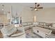 Bright living room features hardwood floors, a ceiling fan, and comfortable seating at 920 Alba Dr, Lebanon, IN 46052