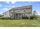 Expansive backyard featuring a screened-in porch, lush green lawn, and manicured landscaping at 952 Workington Cir, Westfield, IN 46074