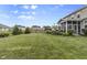 Expansive backyard featuring a well-manicured lawn, tasteful landscaping, and a screened-in porch for outdoor enjoyment at 952 Workington Cir, Westfield, IN 46074