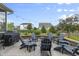Cozy backyard patio with stone fire pit, Adirondack chairs, and charming string lights at 952 Workington Cir, Westfield, IN 46074