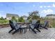 Cozy backyard patio with stone fire pit, Adirondack chairs, and charming string lights at 952 Workington Cir, Westfield, IN 46074