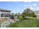 Expansive backyard featuring a screened-in porch, lush green lawn, and manicured landscaping at 952 Workington Cir, Westfield, IN 46074