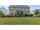 Expansive backyard featuring a screened-in porch, lush green lawn, and manicured landscaping at 952 Workington Cir, Westfield, IN 46074